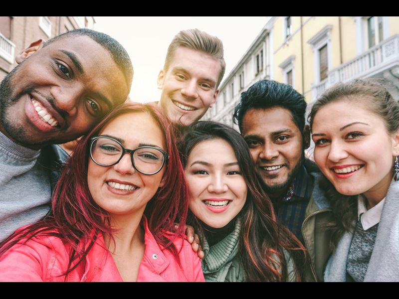 Group of six people smiling at camera
