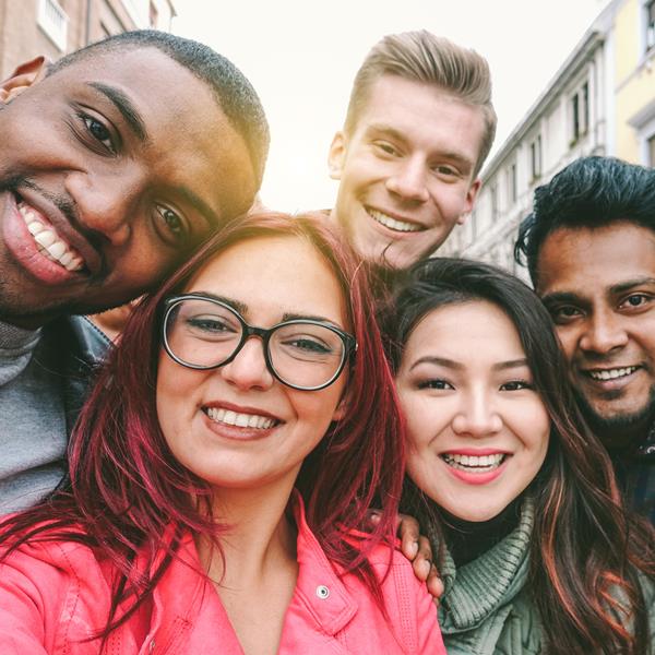 Group of six people smiling at camera
