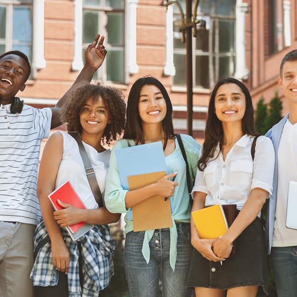 Five students standing together and smiling