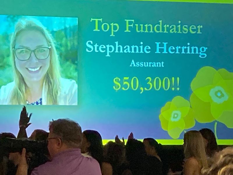 Assurant Employee, Stephanie Herring, receiving award for Top Fundraiser