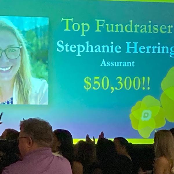 Assurant Employee, Stephanie Herring, receiving award for Top Fundraiser