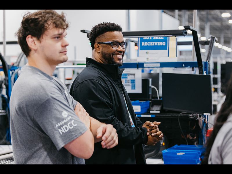 Two employees in conversation at Device Care Center
