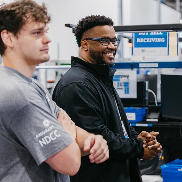 Two employees in conversation at Device Care Center