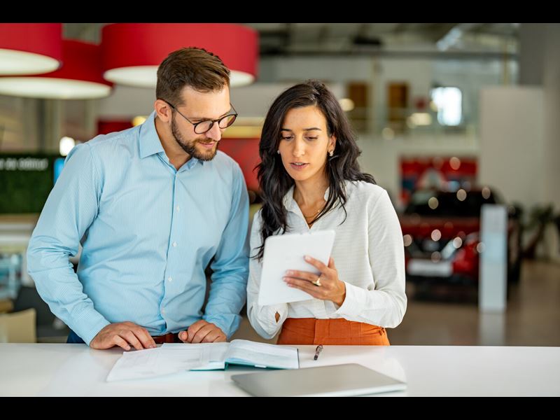 businesswoman in meeting using digital tablet and discussing business strategy (1)