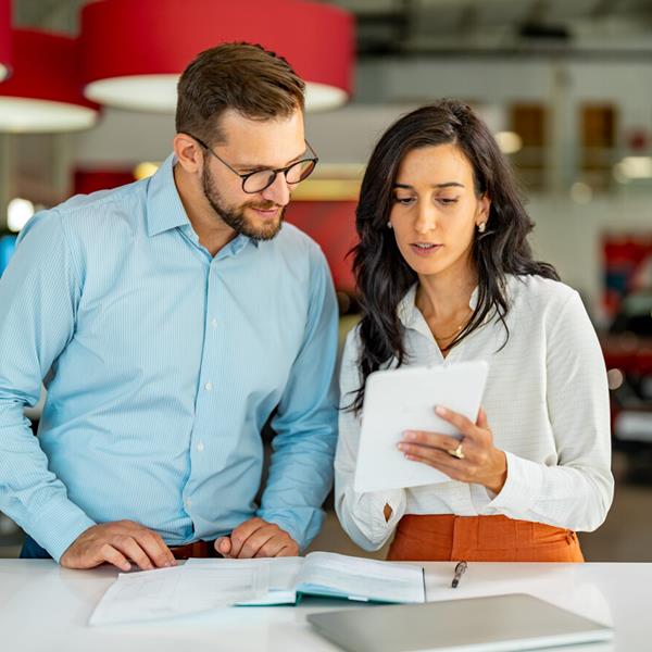 businesswoman in meeting using digital tablet and discussing business strategy (1)