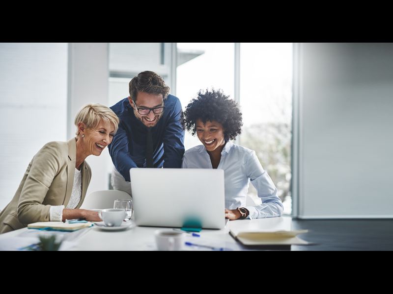 Employees Collaborating In A Hybrid Work Setting