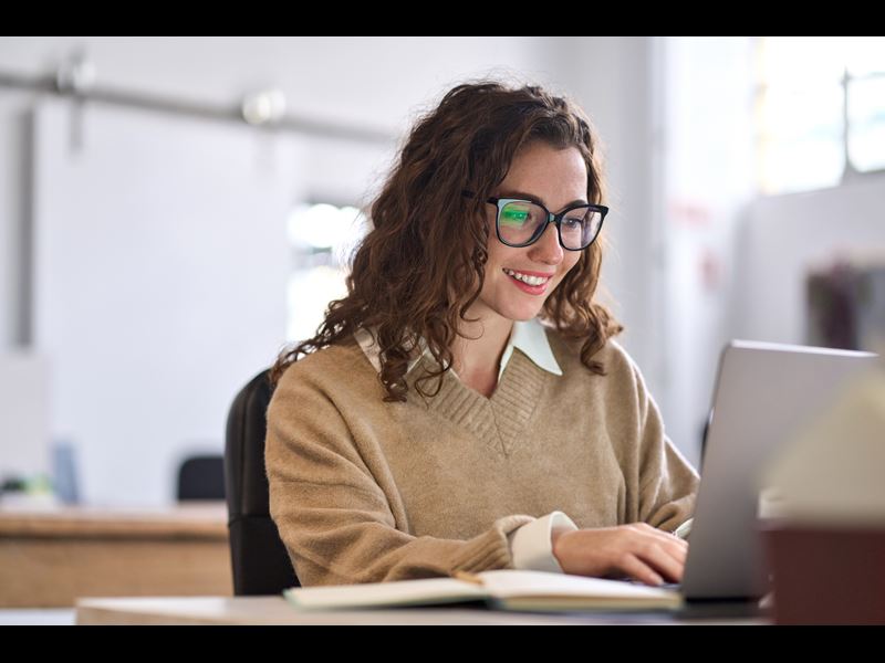 Female Student Smiling With Laptop