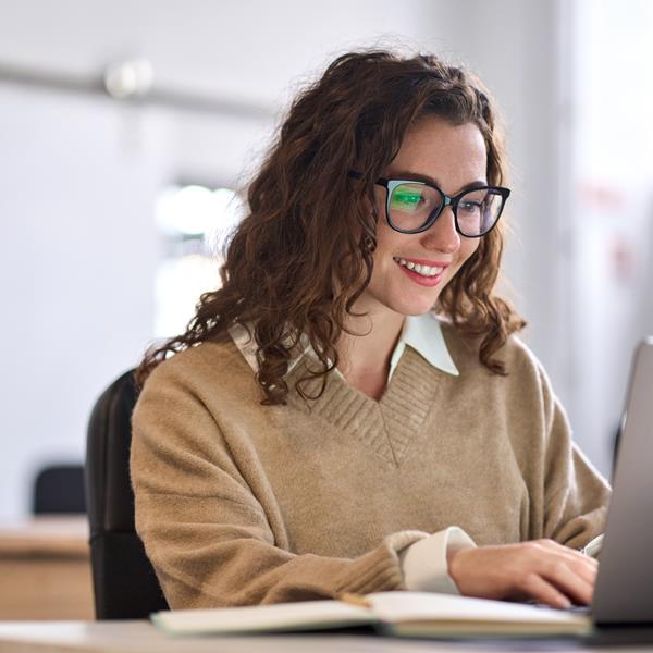 Female Student Smiling With Laptop