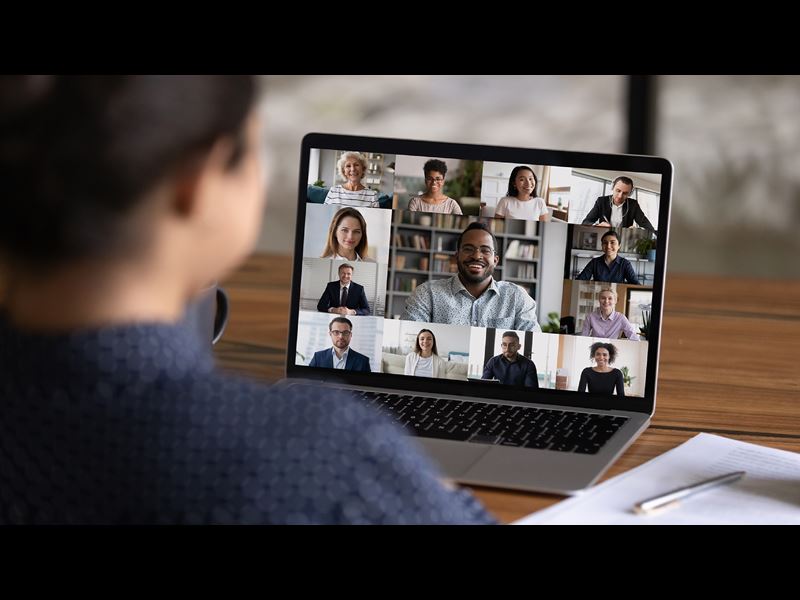 Woman on video conference call with colleagues while working from home