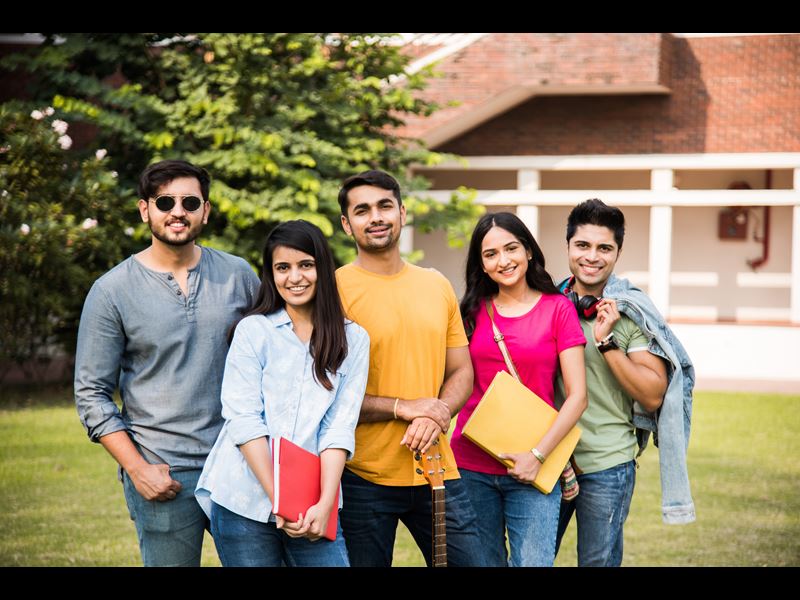 Group of five college students smiling at camera