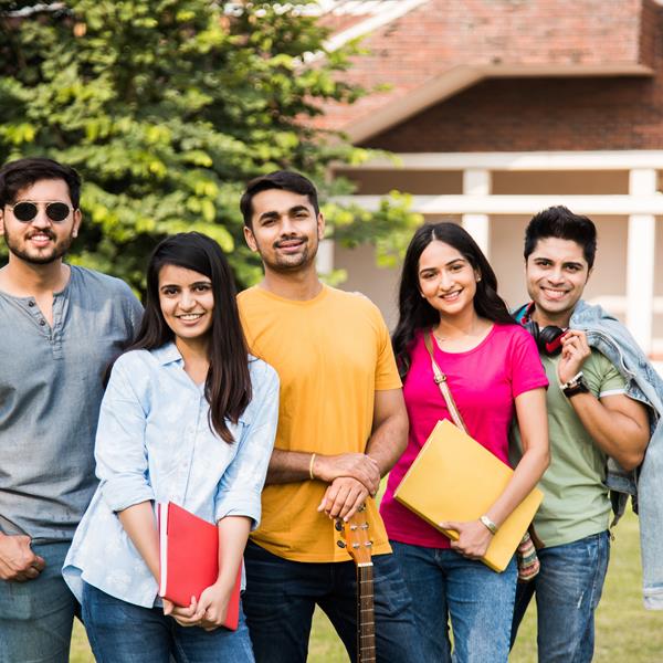 Group of five college students smiling at camera
