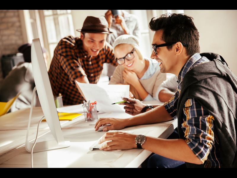 Team Working Together With Laptop