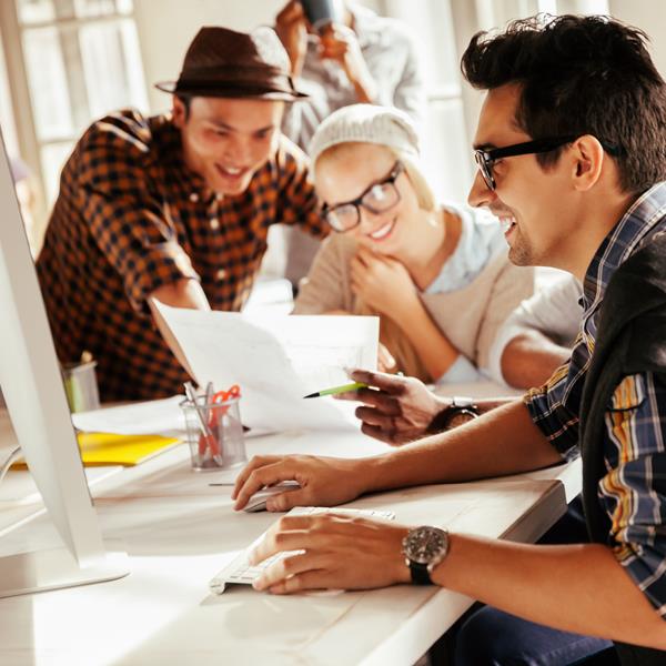 Team Working Together With Laptop