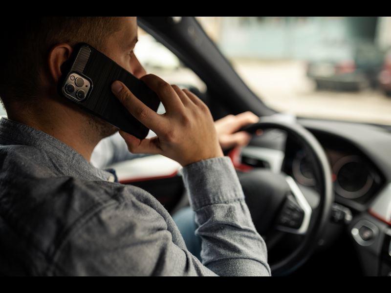 Man speaking on phone while driving car