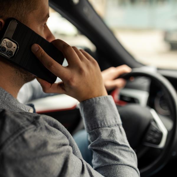 Man speaking on phone while driving car