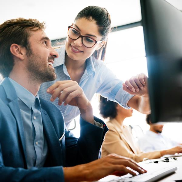 Two people discussing work in office