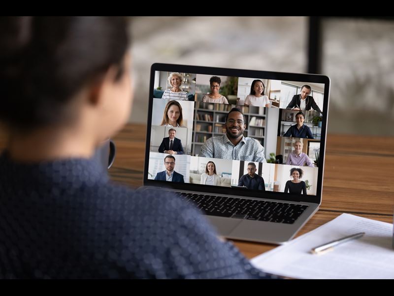 Woman talking to coworkers over video call