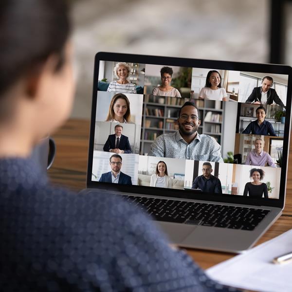 Woman talking to coworkers over video call
