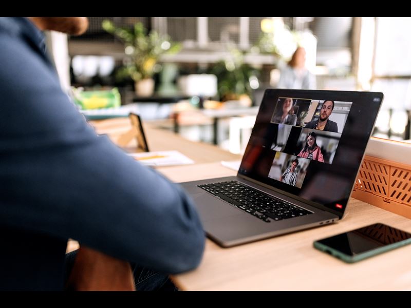 Person Sitting On A Video Conference On Laptop