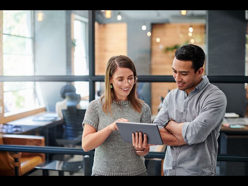 businesswoman in meeting using digital tablet and discussing business strategy