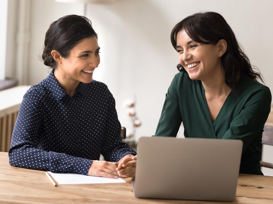 Two Female Employees Smiling With Laptop