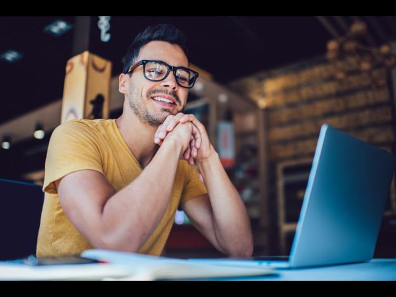 Man smiling at laptop