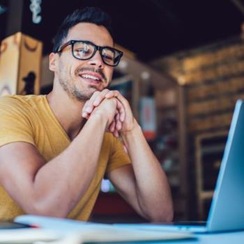 Man smiling at laptop