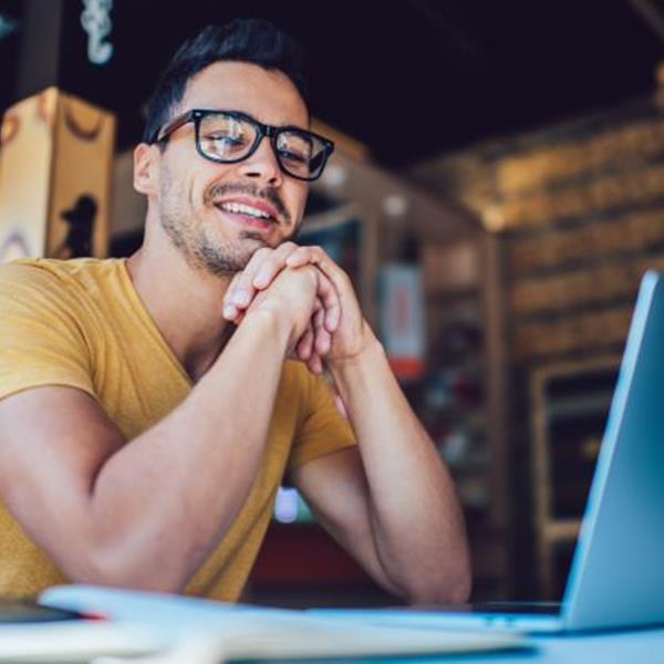 Man smiling at laptop