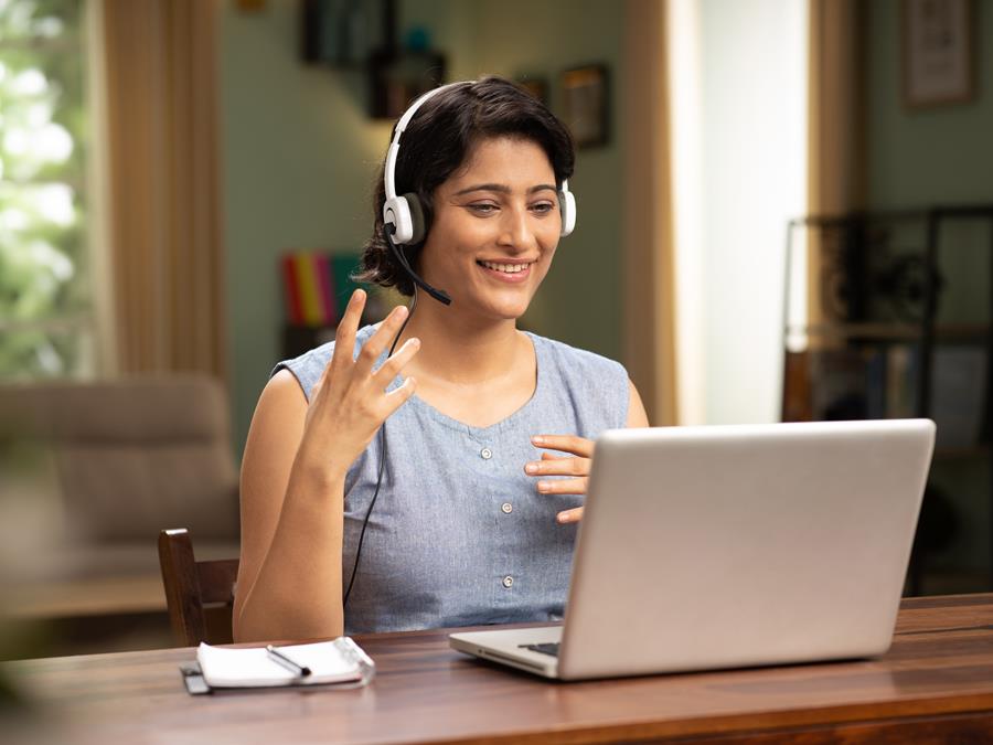 Woman With Headset Talking On Laptop