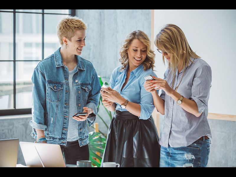 BUSINESS TEAM Women Designers Standing Meeting Getty 673240330 LR