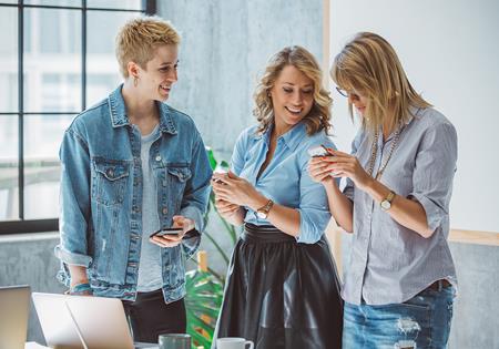 BUSINESS TEAM Women Designers Standing Meeting Getty 673240330 LR
