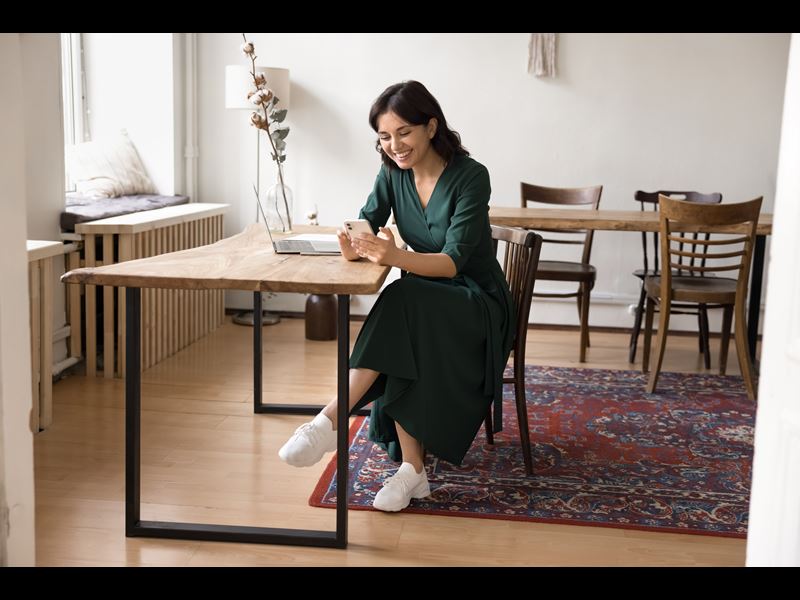 Woman Smiling And Texting On Phone