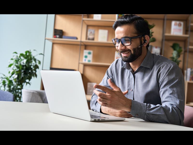 Assurant Blog Header Image Man Smiling With Laptop