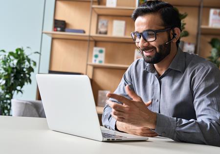 Assurant Blog Header Image Man Smiling With Laptop
