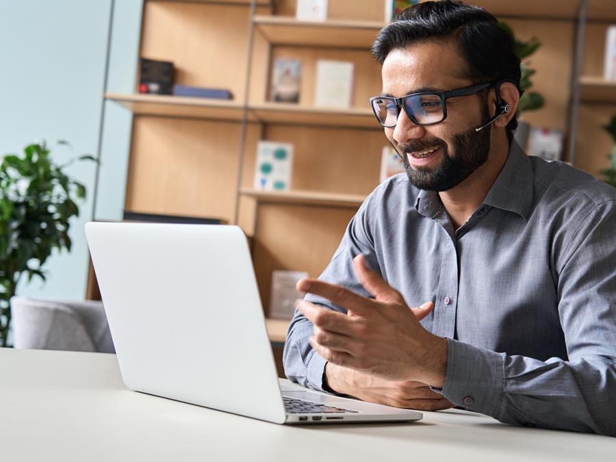 Assurant Blog Header Image Man Smiling With Laptop
