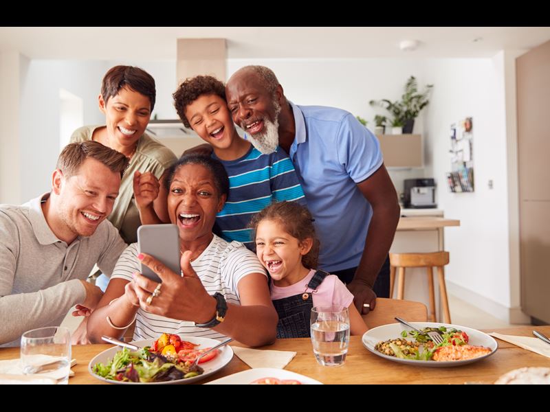 Assurant Blog Image: Family of six people smiling at phone