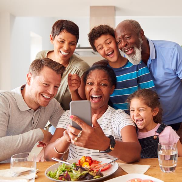 Assurant Blog Image: Family of six people smiling at phone