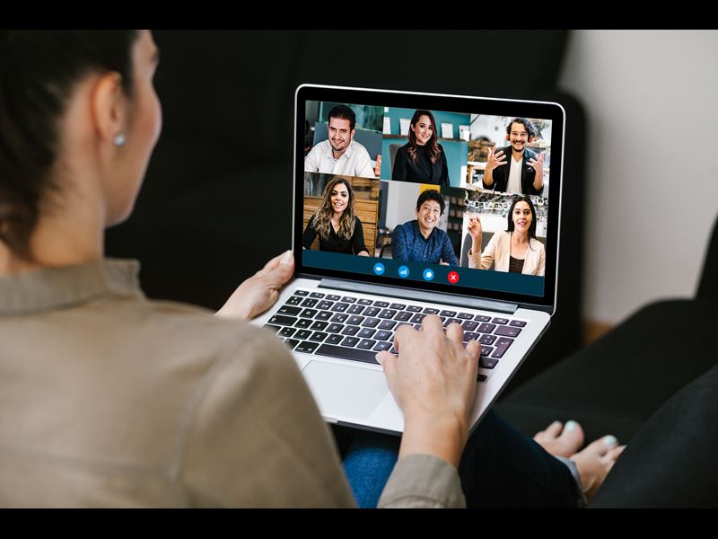 Woman talking to colleagues on video call