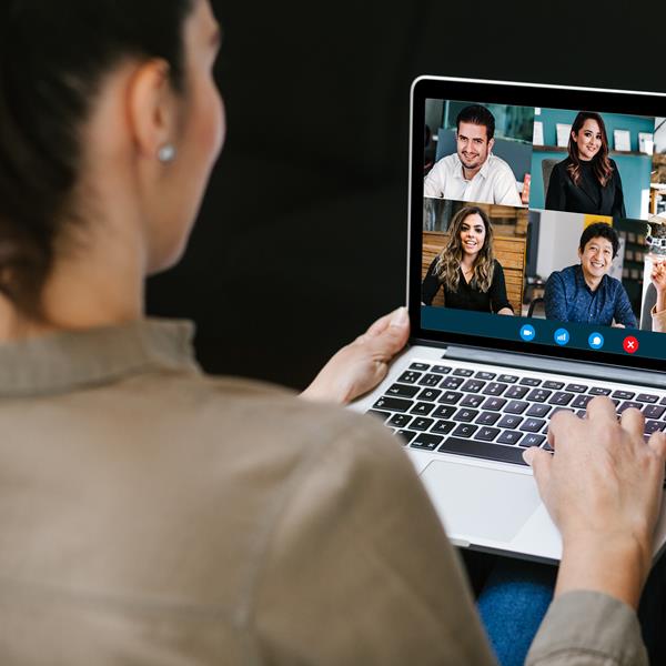 Woman talking to colleagues on video call