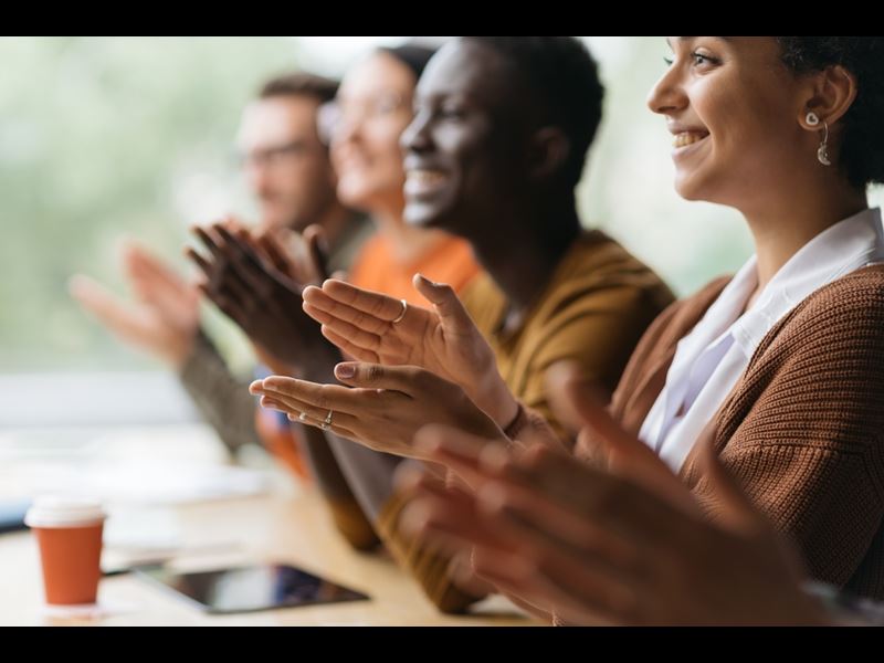 Diverse Employees Smiling And Applauding